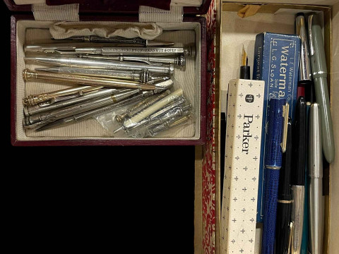 Two boxes of pens and propelling pencils, including silver.