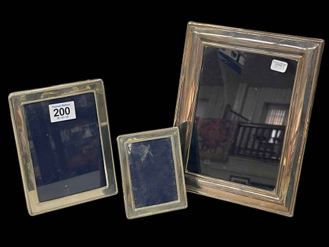 Three silver photograph frames.