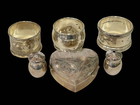 Collection of small silver items to include three napkin rings, heart...