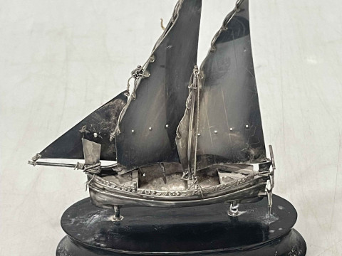Sterling silver model of a masted sailing ship on ebonised base.