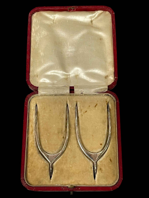 Pair of silver wishbone design sugar nips in box.