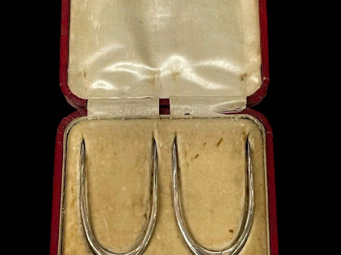 Pair of silver wishbone design sugar nips in box.