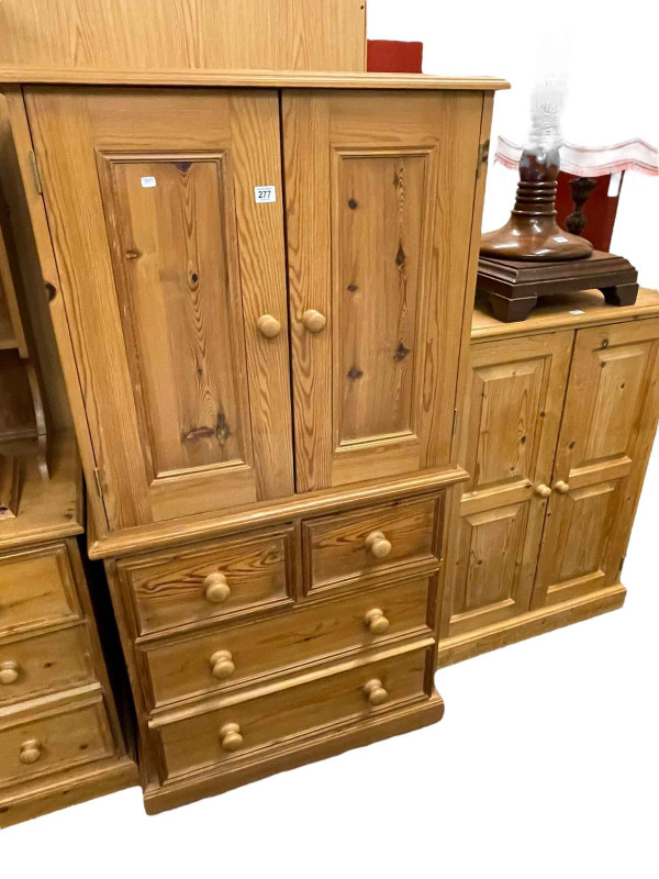 Pine entertainment cabinet having two doors above four drawers and pine two door linen cupboard (2).