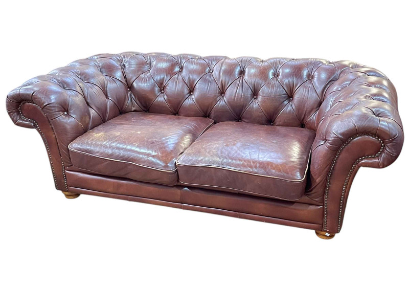 Brown buttoned leather and brass studded two seater Chesterfield settee, 67cm by 201cm by 106cm.