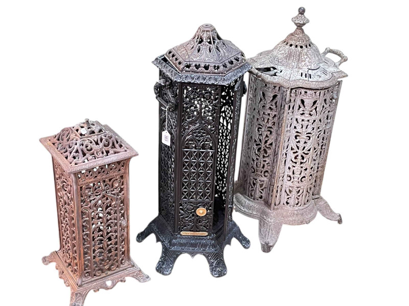 Three cast fretwork Cathedral heaters, largest 80cm by 41cm by 38cm.
