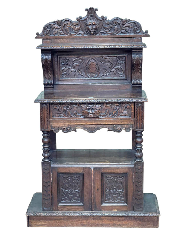 Victorian carved oak buffet having raised back above a single drawer raised on turned pillars with two cupboard doors below, 145cm by 90cm by 34cm.