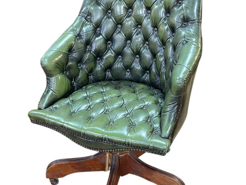 Green fully buttoned leather and brass studded swivel office chair.