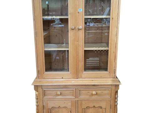 Pine cabinet bookcase having two glazed panel doors above two drawers...