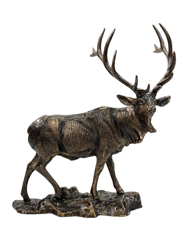 Bronzed model of a standing stag on rocks, 42cm.