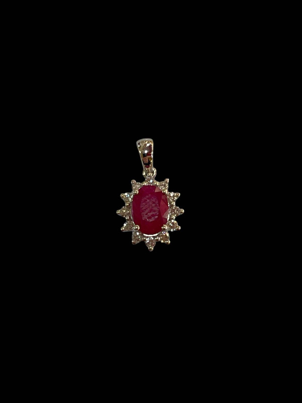 Ruby and diamond pendant set in 18 carat white gold.