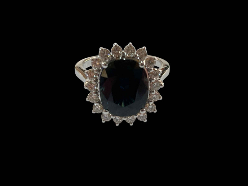 18 carat white gold, sapphire and diamond cluster ring, the sapphire over 5.5 carats, size M.
