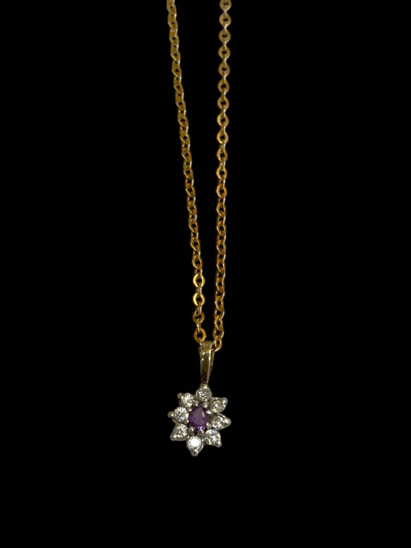 9 carat gold chain with gem flower pendant.