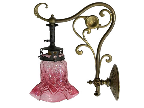 Edwardian gas light wall fitting with ruby tinted shade.
