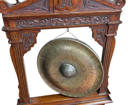 Victorian beaten brass dinner gong on carved oak stand, 130cm by 83cm...