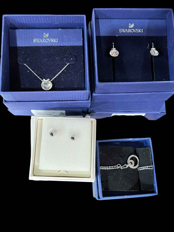 Swarovski, four boxed pieces of jewellery.