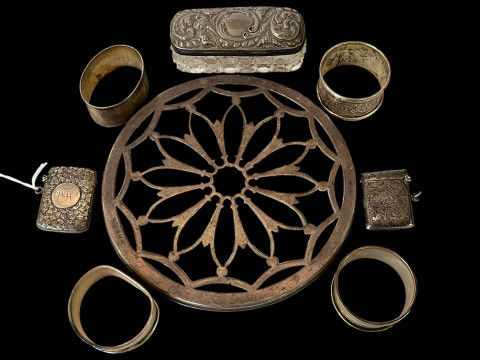 Two silver vesta cases, four napkin rings, toilet jar and teapot stand...