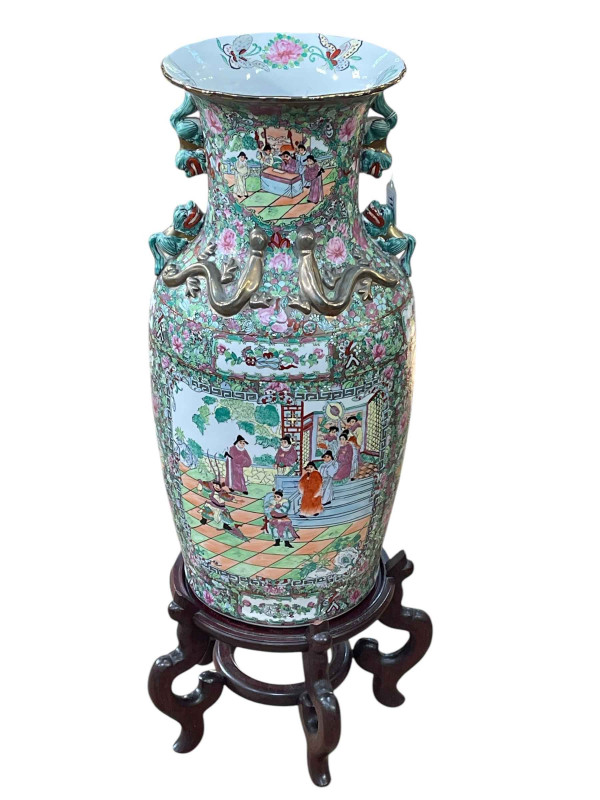 Large pair of floor standing Cantonese famille rose vases with decorated panels on floral ground each on six footed wooden stands, 86cm including stand.