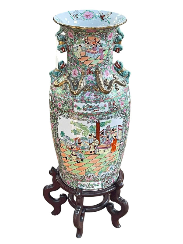 Large pair of floor standing Cantonese famille rose vases with decorated panels on floral ground each on six footed wooden stands, 86cm including stand.