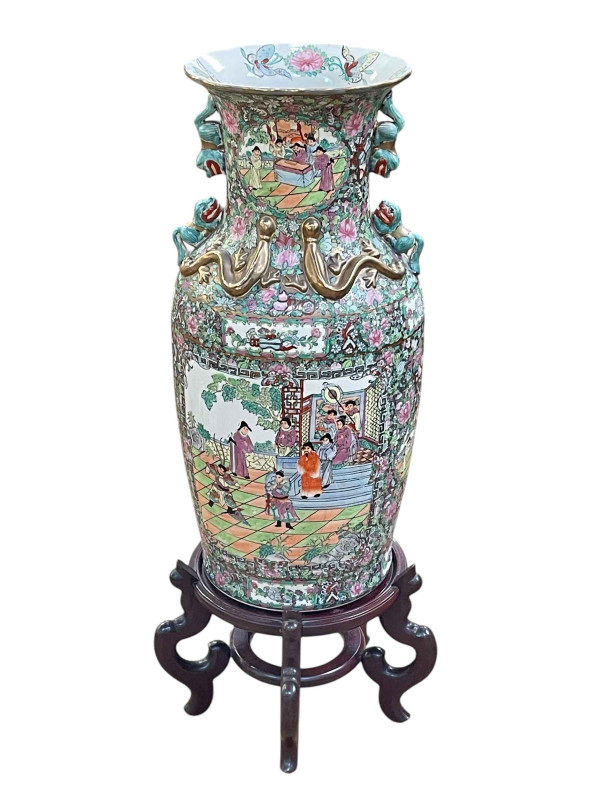 Large pair of floor standing Cantonese famille rose vases with decorated panels on floral ground each on six footed wooden stands, 86cm including stand.