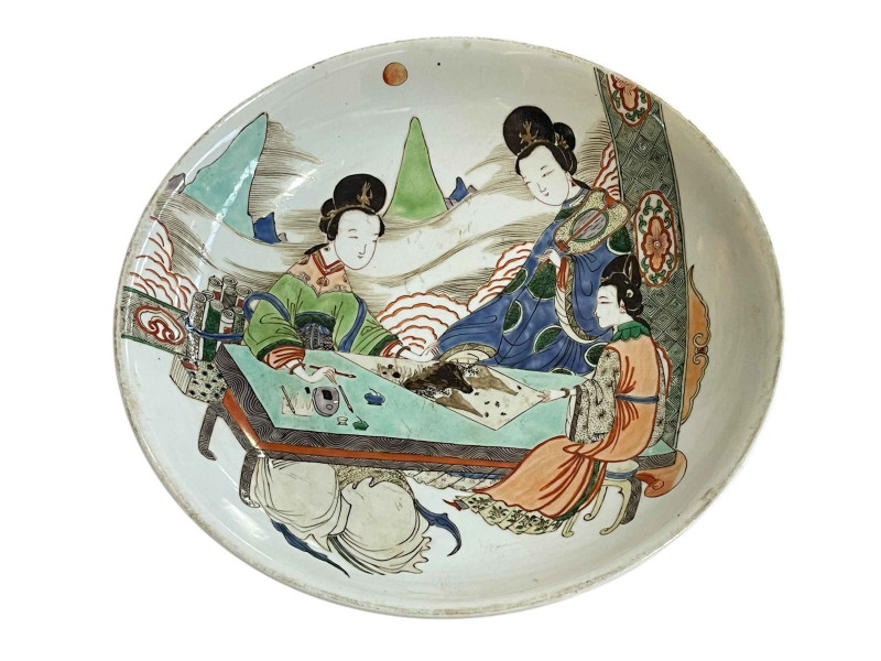 Chinese pottery circular dish decorated with geisha at a coffee table admiring a shanshui scroll, the base with a leaf motif within a double circle, 28.5cm.