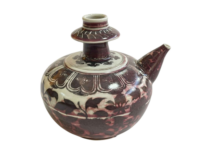 Chinese pottery ewer with flower and leaf design.