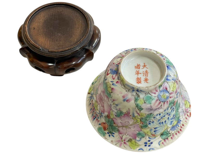 Chinese famille rose floral decorated bowl on wood stand with Qianlong mark to base, height with stand 10cm.