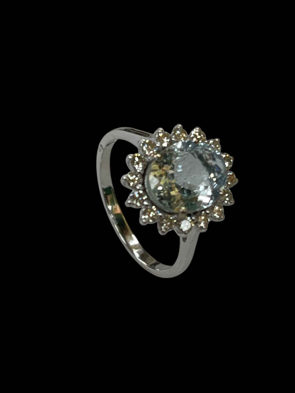 Oval aquamarine and diamond ring set in 18 carat white gold, the central 2 carat aquamarine surrounded by sixteen small diamonds totalling 0.50 carats, size O.