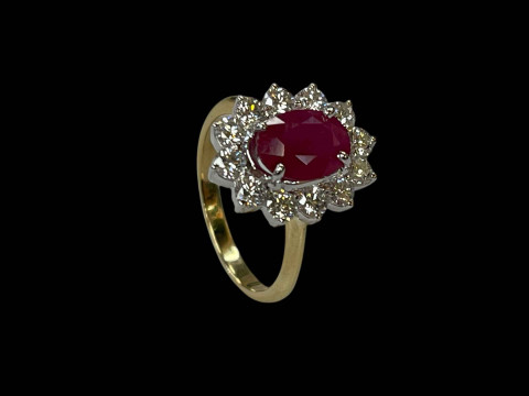 18 carat yellow and white gold oval ruby and diamond cluster ring, the 2.20 carat oval ruby surrounded by twelve diamonds totalling 0.80 carats, size P. thumbnail