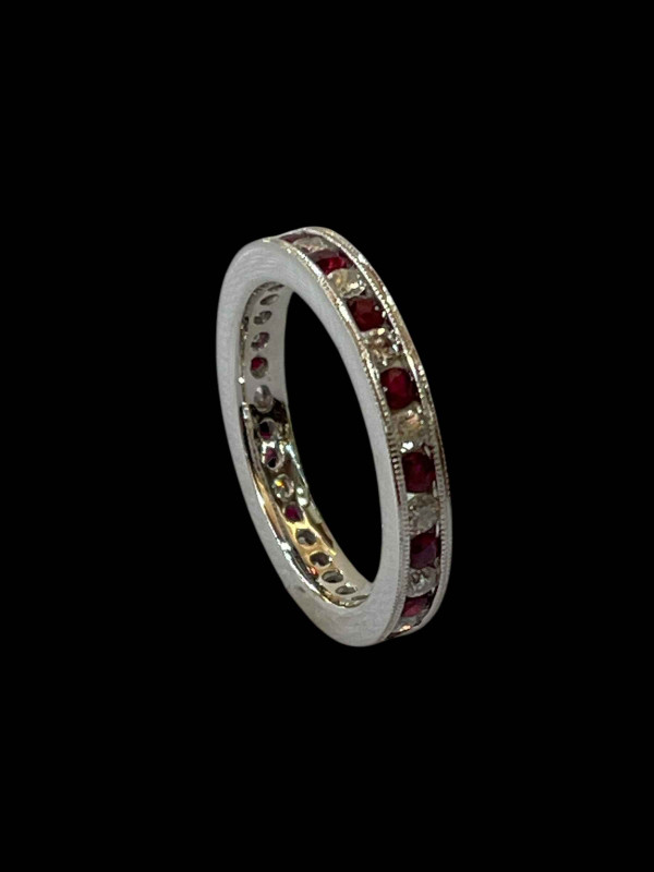 Diamond and ruby 9 carat white gold eternity ring, size N.