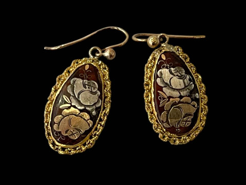 Pair pique pendant earrings.
