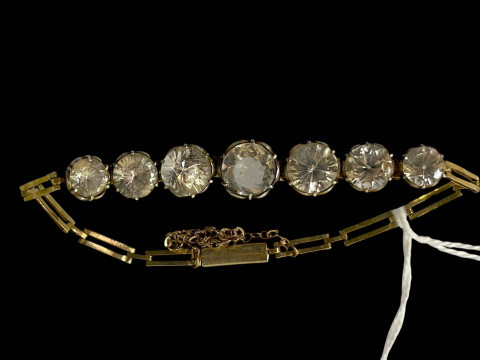 Gold bracelet set with graduated paste stones.