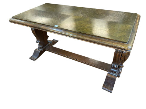 Rectangular oak coffee table raised on carved figural Knight supports...