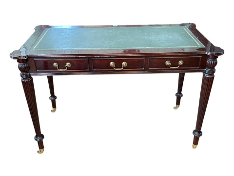 Mahogany reeded leg and inset leather topped three drawer writing table...