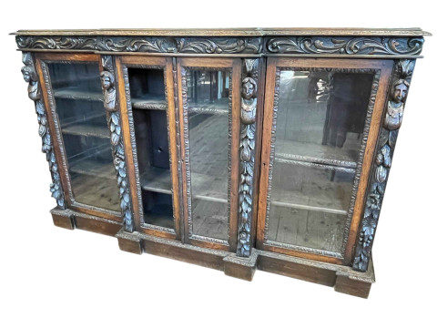 Victorian carved oak breakfront four bookcase, 113cm by 179cm by 36cm.