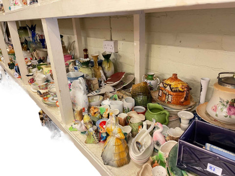 Full shelf of glass and china including Ringtons caddies, ornaments, figurines,...