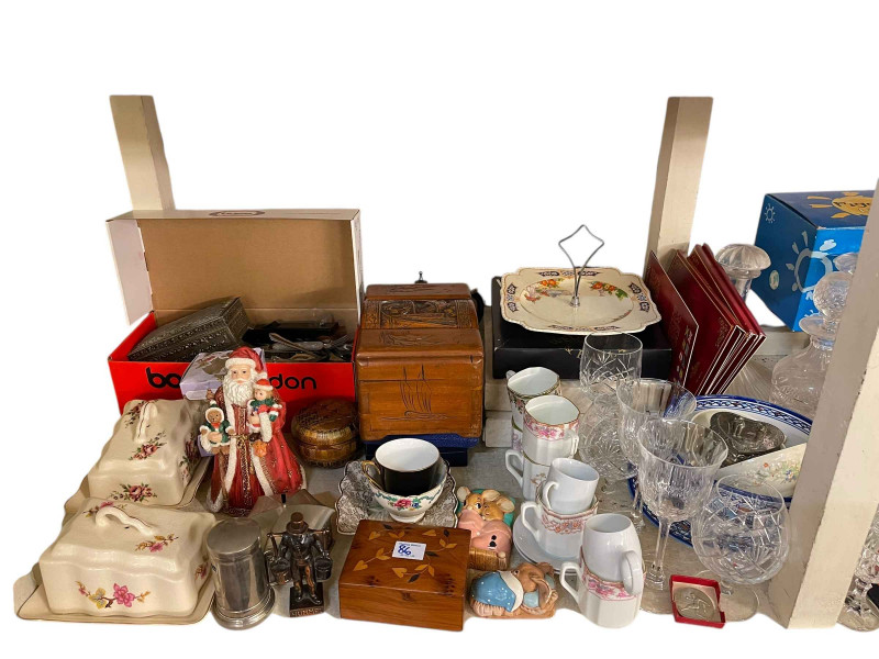 Full shelf of glass and china, cutlery, three boxes of soft toys and linen, etc.