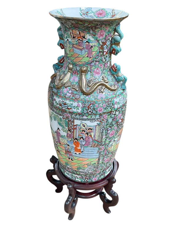 Large pair of floor standing Cantonese famille rose vases with decorated panels on floral ground each on six footed wooden stands, 86cm including stand.