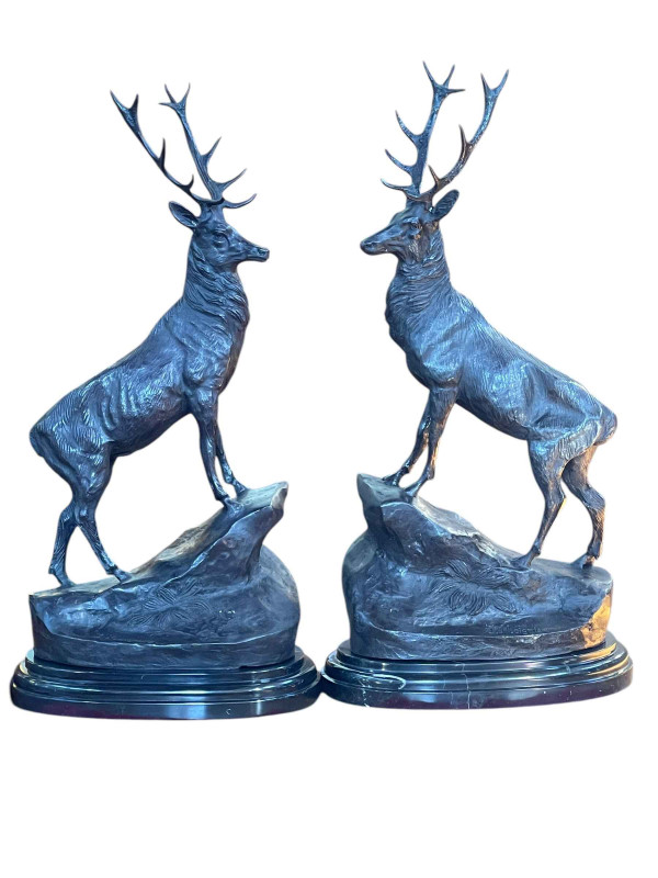 Large impressive pair of bronze stags on rocky outcrops mounted on marble plinths, 72cm.