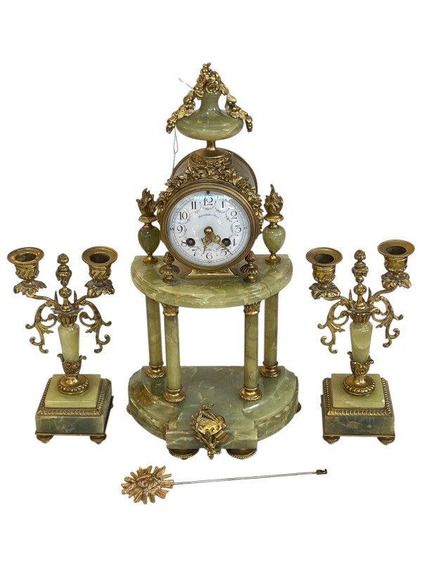 Ornate three piece gilt metal and onyx clock garniture with enamel dial.