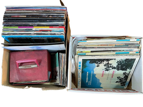 Four boxes of vinyl LP records and singles.