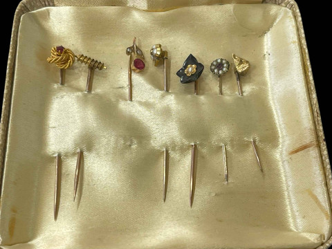 Collection of seven mostly gold stick pins including 15 carat gold rope...