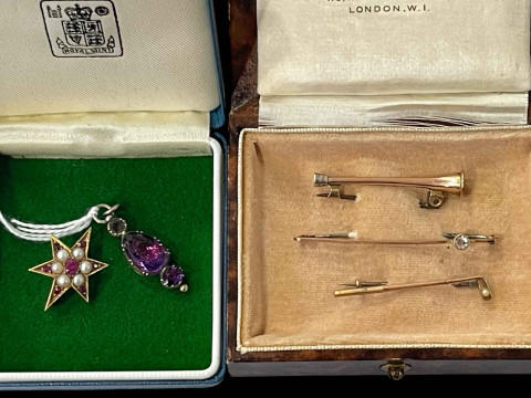 Three gold stock pins, pearl and gem stone gold star brooch, and a pendant...