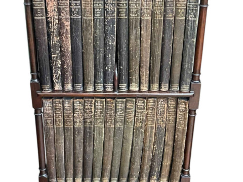 Edwardian mahogany two tier open bookcase on pad feet with a complete...