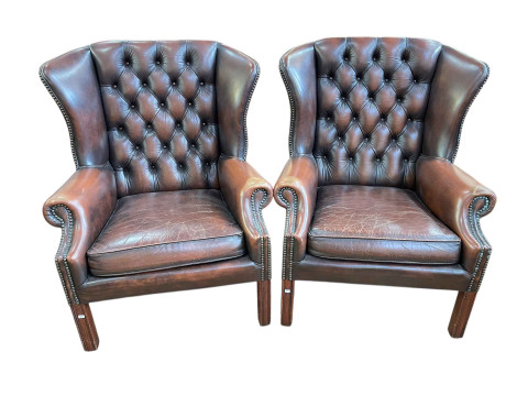 Pair brown leather button backed and brass studded wing armchairs, 96cm...
