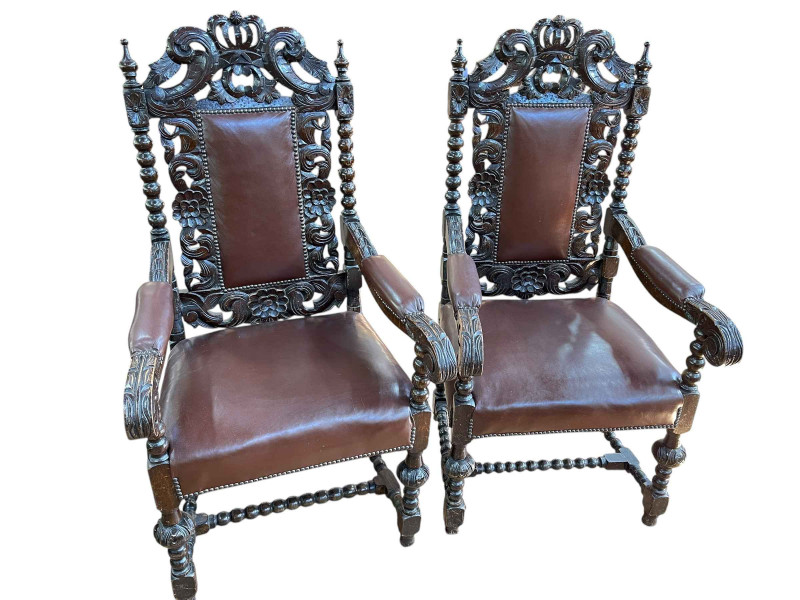 Pair carved oak hide and brass buttoned open armchairs with bobbin supports, 124cm by 63cm by 55cm.