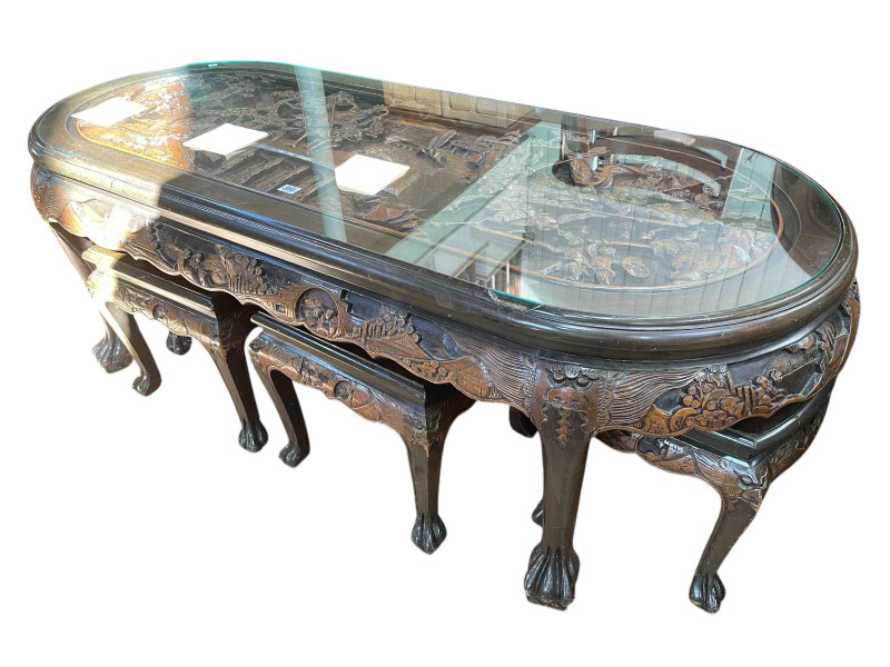 Large Oriental carved oval low centre table and six stools, table, 52cm by 157cm by 70cm.