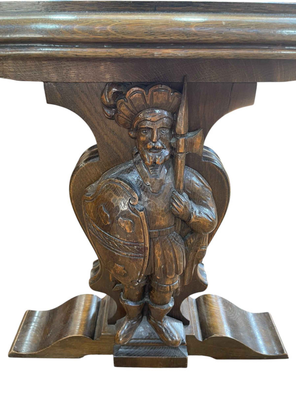 Rectangular oak coffee table raised on carved figural Knight supports joined by stretcher, 57cm by 116cm by 60cm.