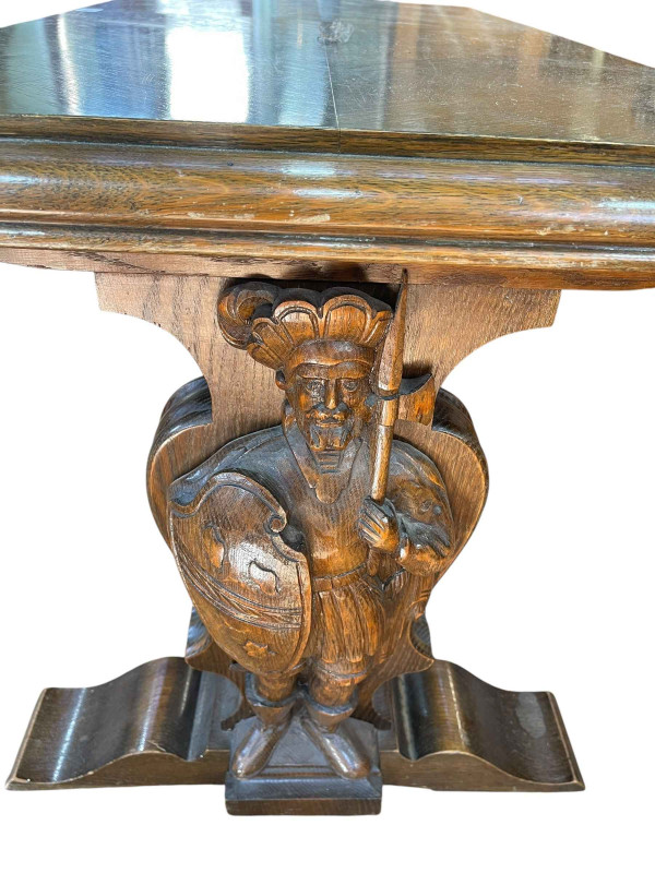 Rectangular oak coffee table raised on carved figural Knight supports joined by stretcher, 57cm by 116cm by 60cm.