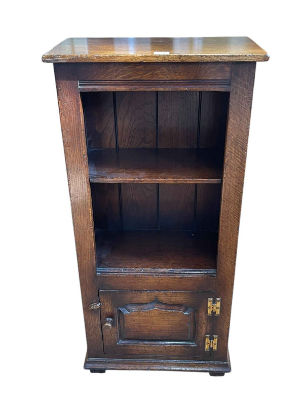 Titchmarsh & Goodwin oak bookcase, the open top with one shelf above an ogee shaped fielded panel door, 97cm by 46.5cm by 25.5cm.