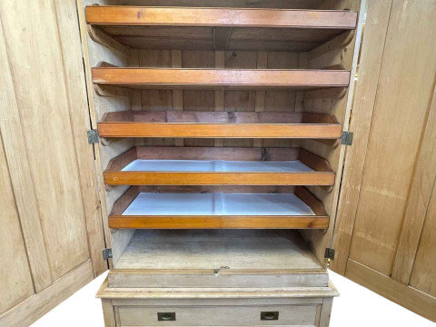 Victorian pine wardrobe having two doors enclosing five sliding trays above a base of two long drawers, 226cm by 141cm by 65cm. thumbnail